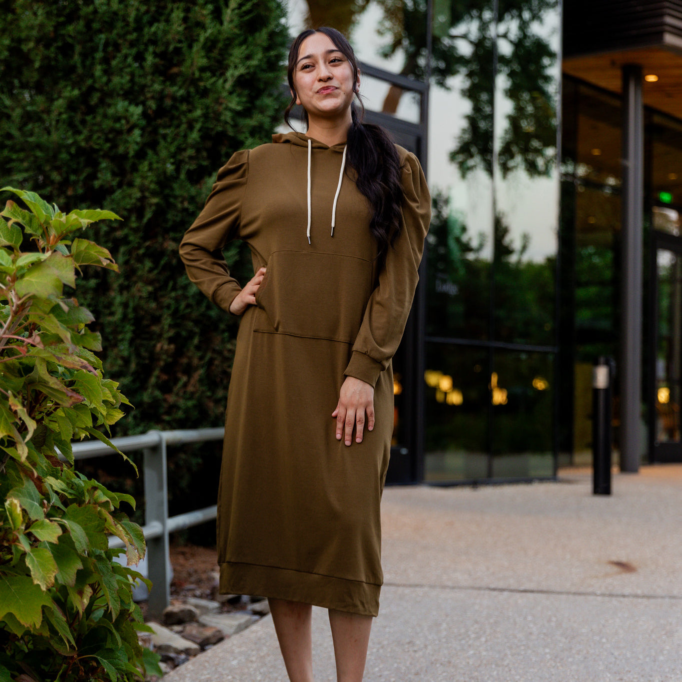 Model wearing Nuggles® Zoelle Dress in solid color, modest hoodie dress with puff sleeves.