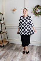 Model wearing the 3/4 Sleeve Victoria Top in floral print, paired with a modest Classic skirt. Modest women’s fashion with 3/4 sleeves and hip-length fit, perfect for church, work, or everyday wear.