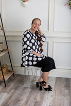 Model wearing the 3/4 Sleeve Victoria Top in floral print, paired with a modest Classic skirt. Modest women’s fashion with 3/4 sleeves and hip-length fit, perfect for church, work, or everyday wear.