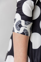 Model wearing the 3/4 Sleeve Victoria Top in floral print, paired with a modest Classic skirt. Modest women’s fashion with 3/4 sleeves and hip-length fit, perfect for church, work, or everyday wear.