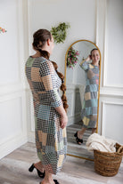 Model wearing the Cindy Bubble Dress with elbow-length sleeves, a modest neckline, and a gathered bubble hem in a midi-length silhouette.