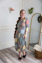 Model wearing the Cindy Bubble Dress with elbow-length sleeves, a modest neckline, and a gathered bubble hem in a midi-length silhouette.