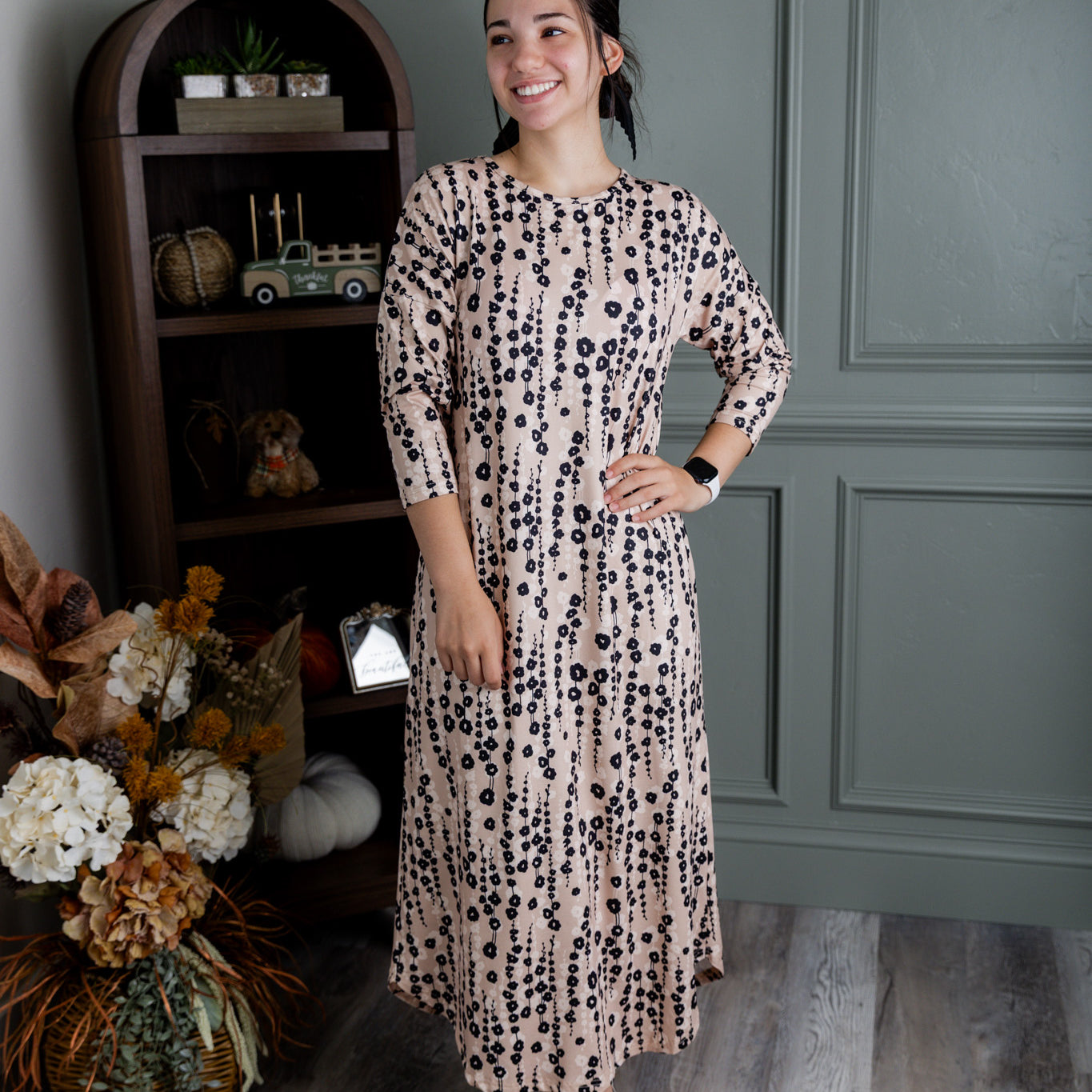 Model wearing Nuggles® Kate Dress in printed fabric, modest midi length with three-quarter sleeves.