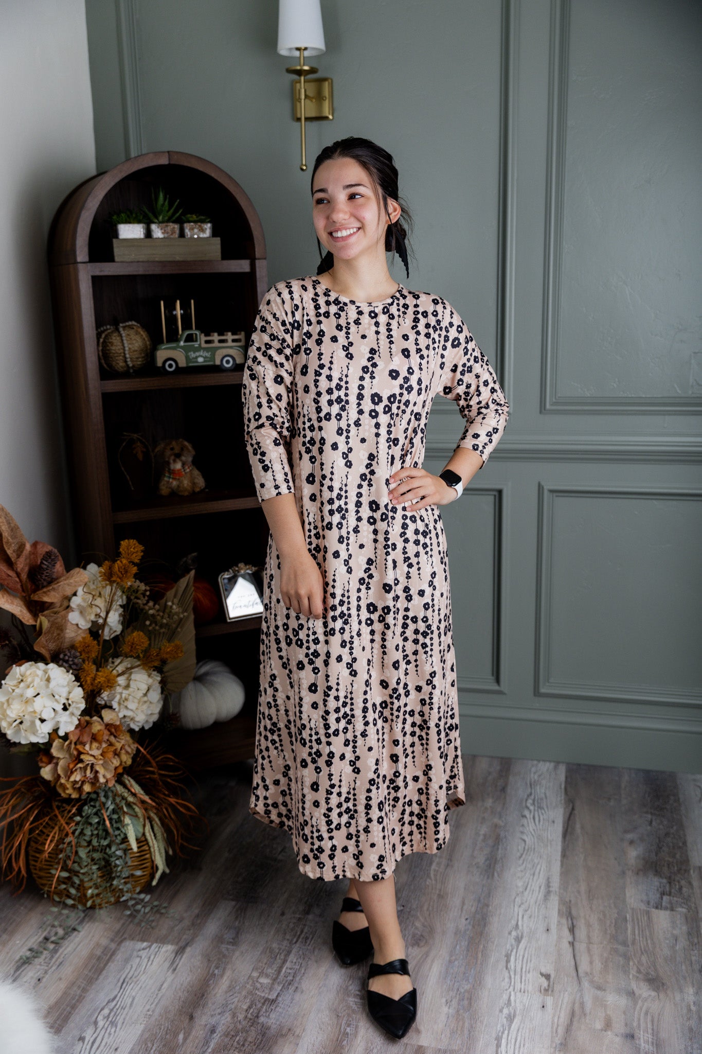 Model wearing Nuggles® Kate Dress in printed fabric, modest midi length with three-quarter sleeves.