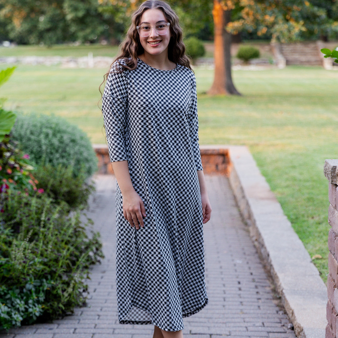 Model wearing Nuggles® Kate Dress in printed fabric, modest midi length with three-quarter sleeves.