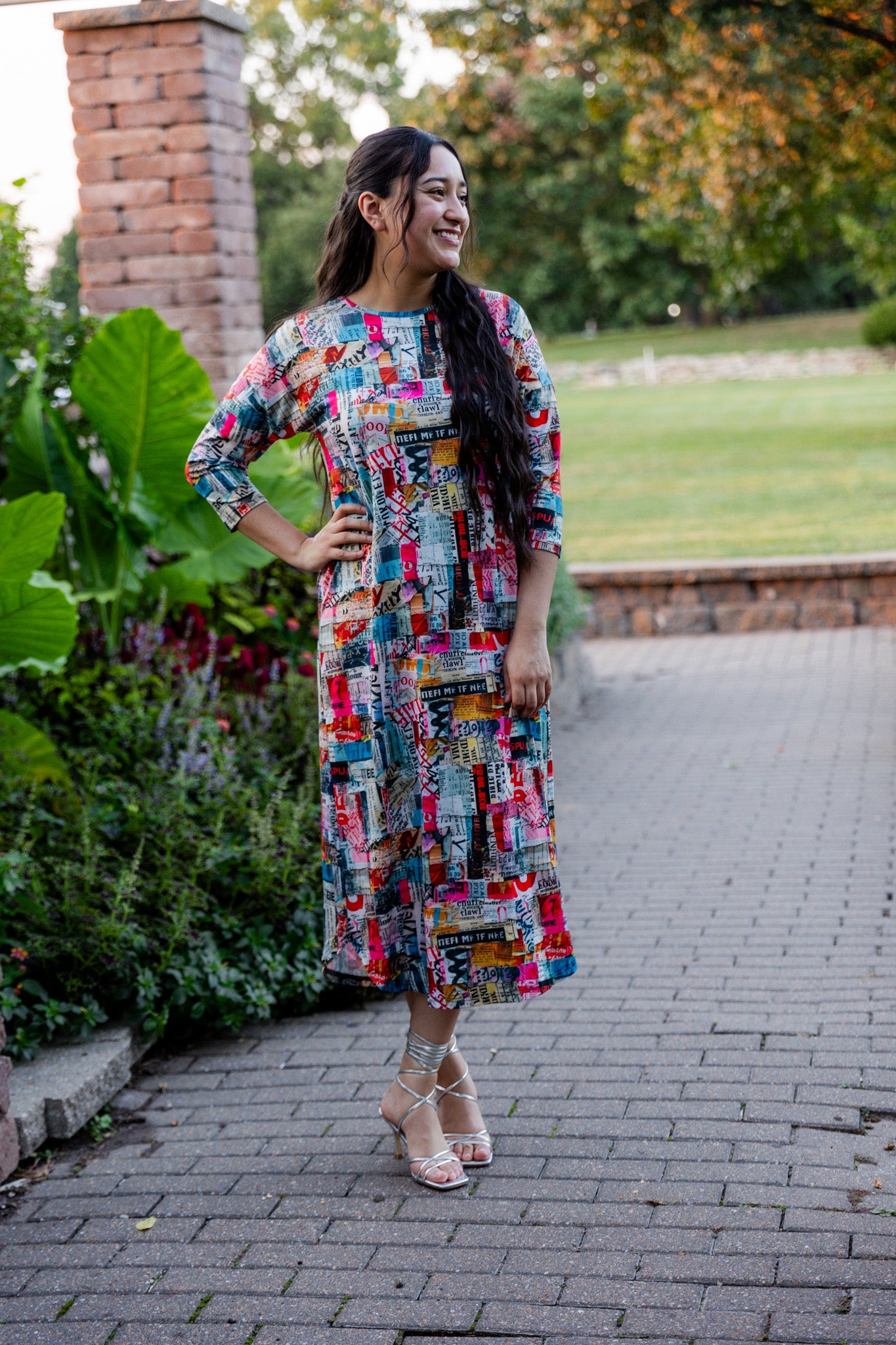 Model wearing Nuggles® Kate Dress in printed fabric, modest midi length with three-quarter sleeves.