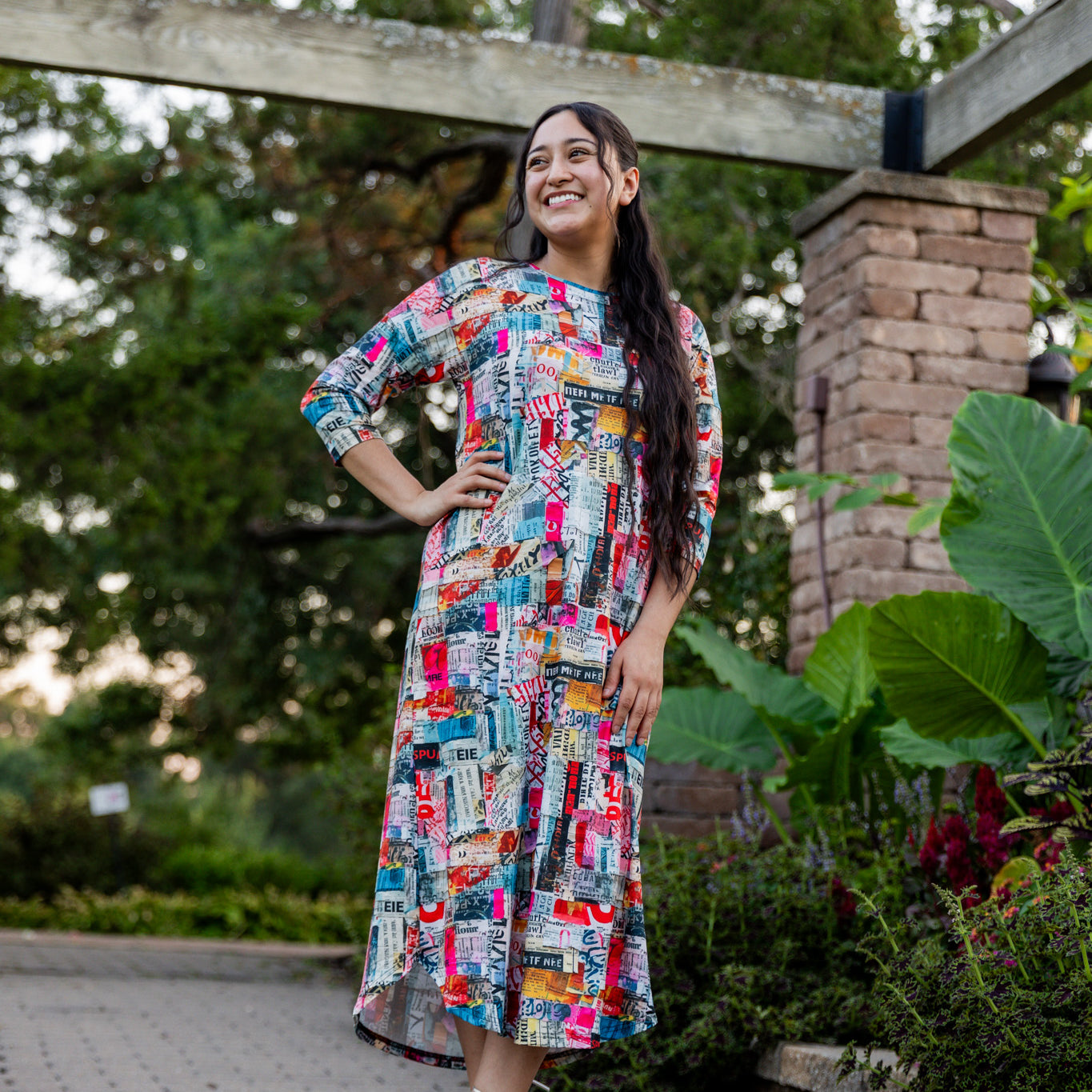 Model wearing Nuggles® Kate Dress in printed fabric, modest midi length with three-quarter sleeves.