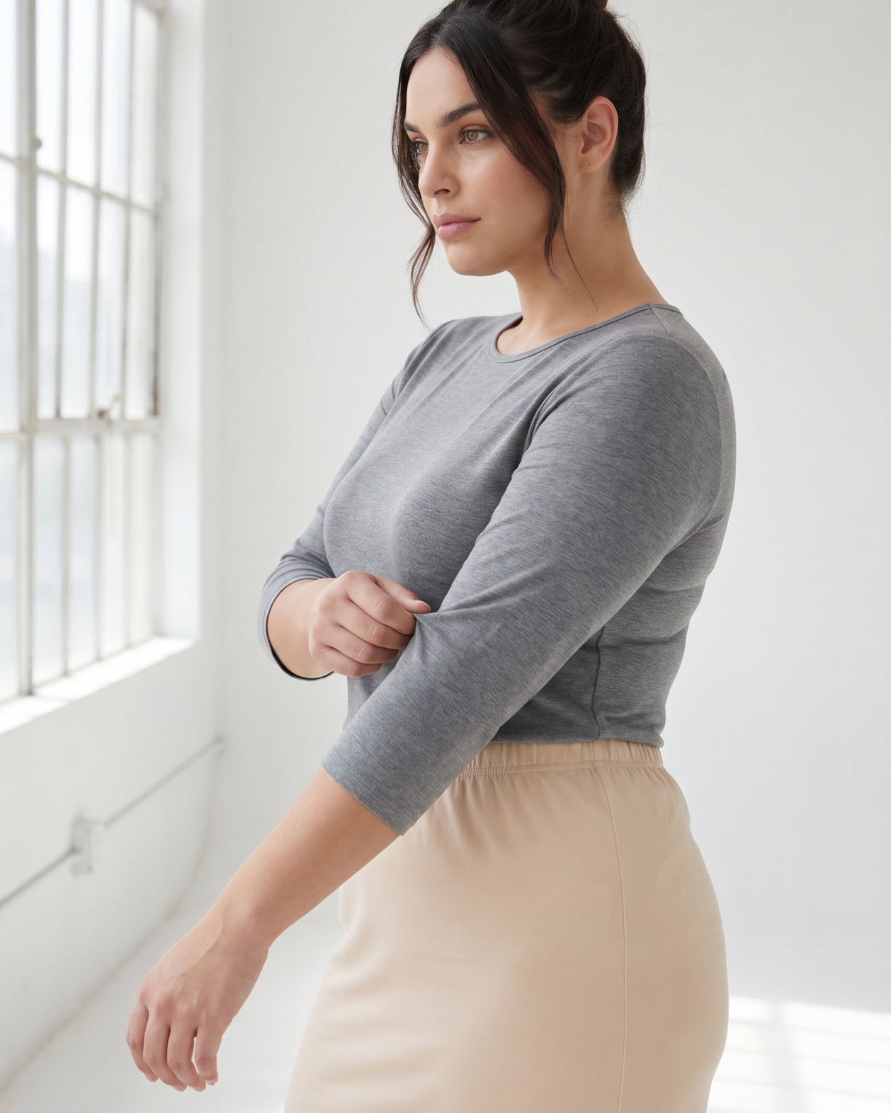 Model wearing Nuggles® 3/4 Essential Tee in Dark Heather