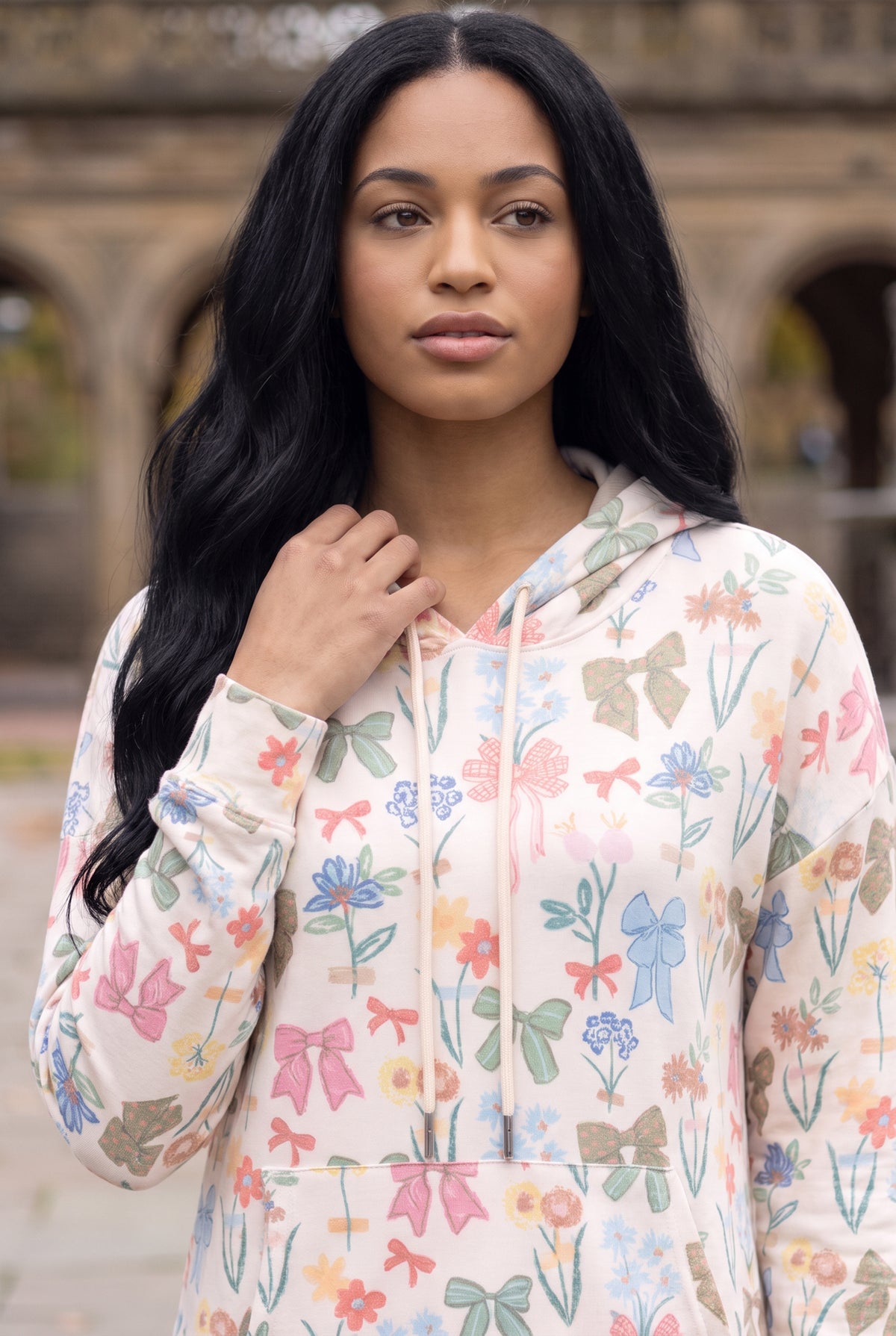 Nuggles® Hoodie Dress in Garden Party, waist-up crop showing the cream drawstring and print detail