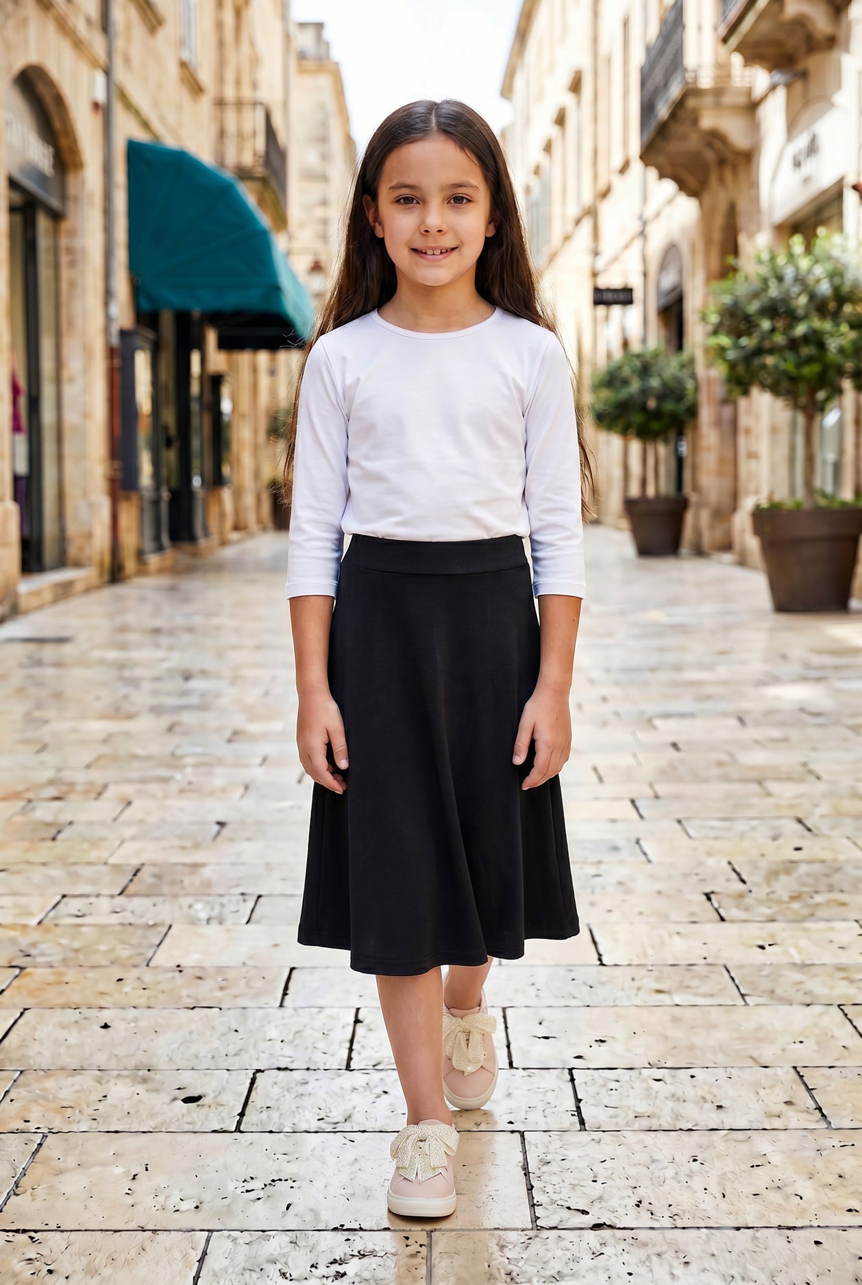 Model wearing Nuggles® Girl's Athleisure Skirt in Black