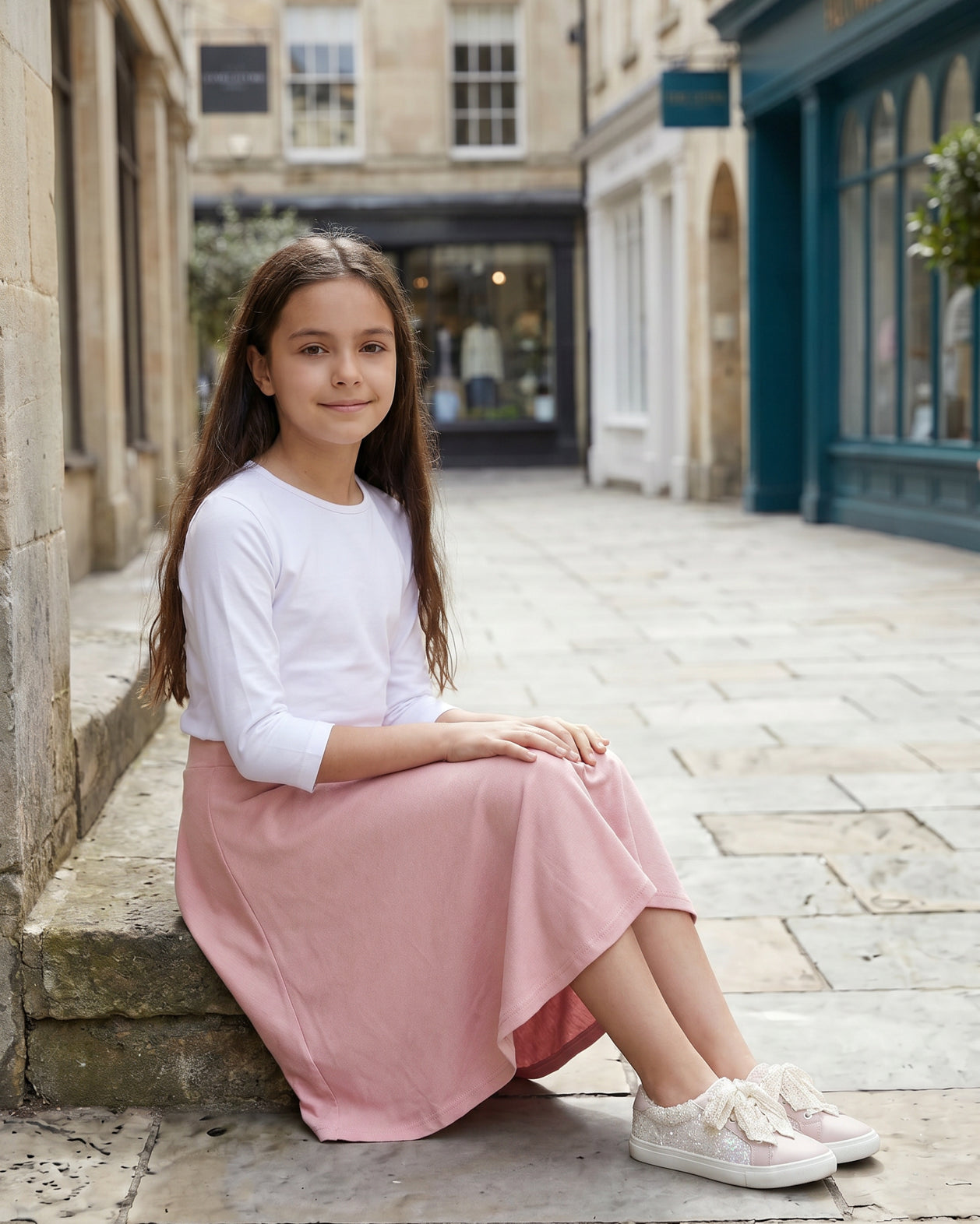 Model wearing Nuggles® Girl's Athleisure Skirt in Dusty Pink