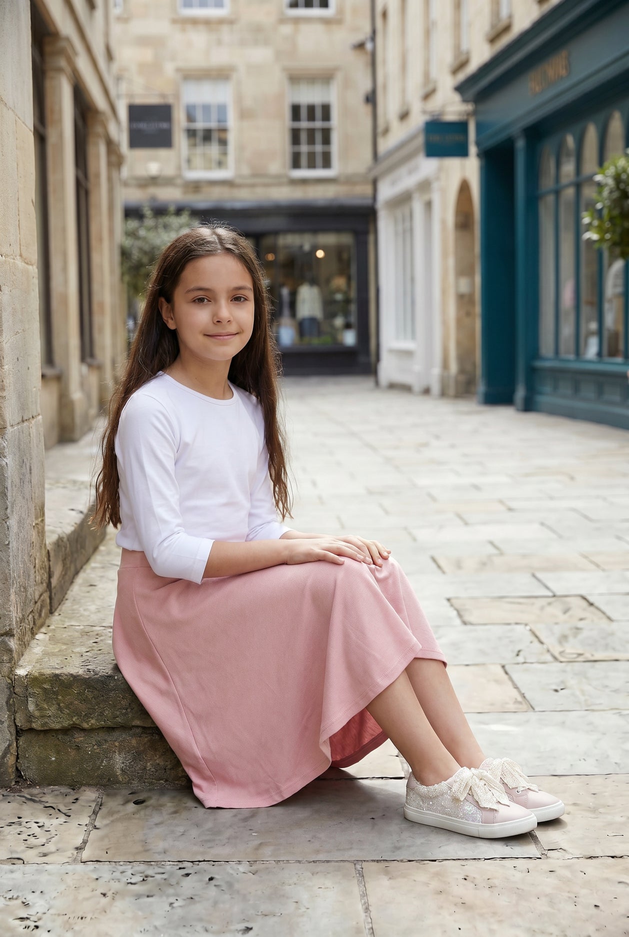 Model wearing Nuggles® Girl's Athleisure Skirt in Dusty Pink