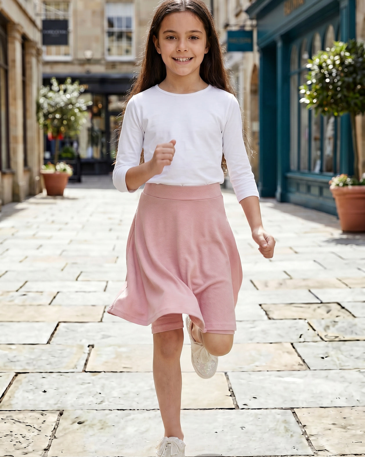 Model wearing Nuggles® Girl's Athleisure Skirt in Dusty Pink