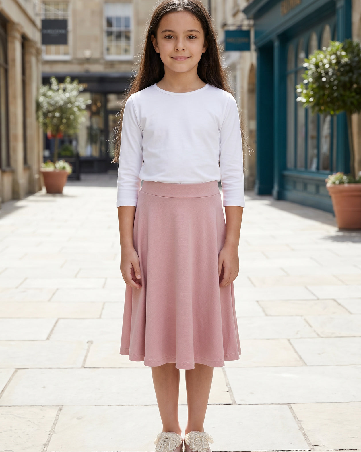 Model wearing Nuggles® Girl's Athleisure Skirt in Dusty Pink