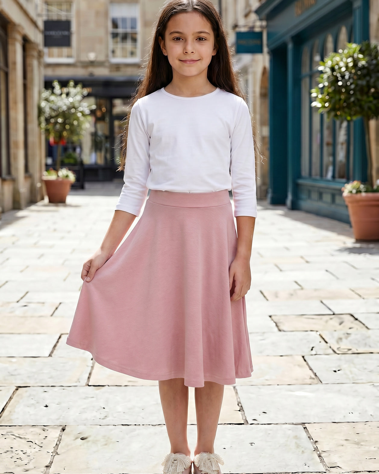 Model wearing Nuggles® Girl's Athleisure Skirt in Dusty Pink