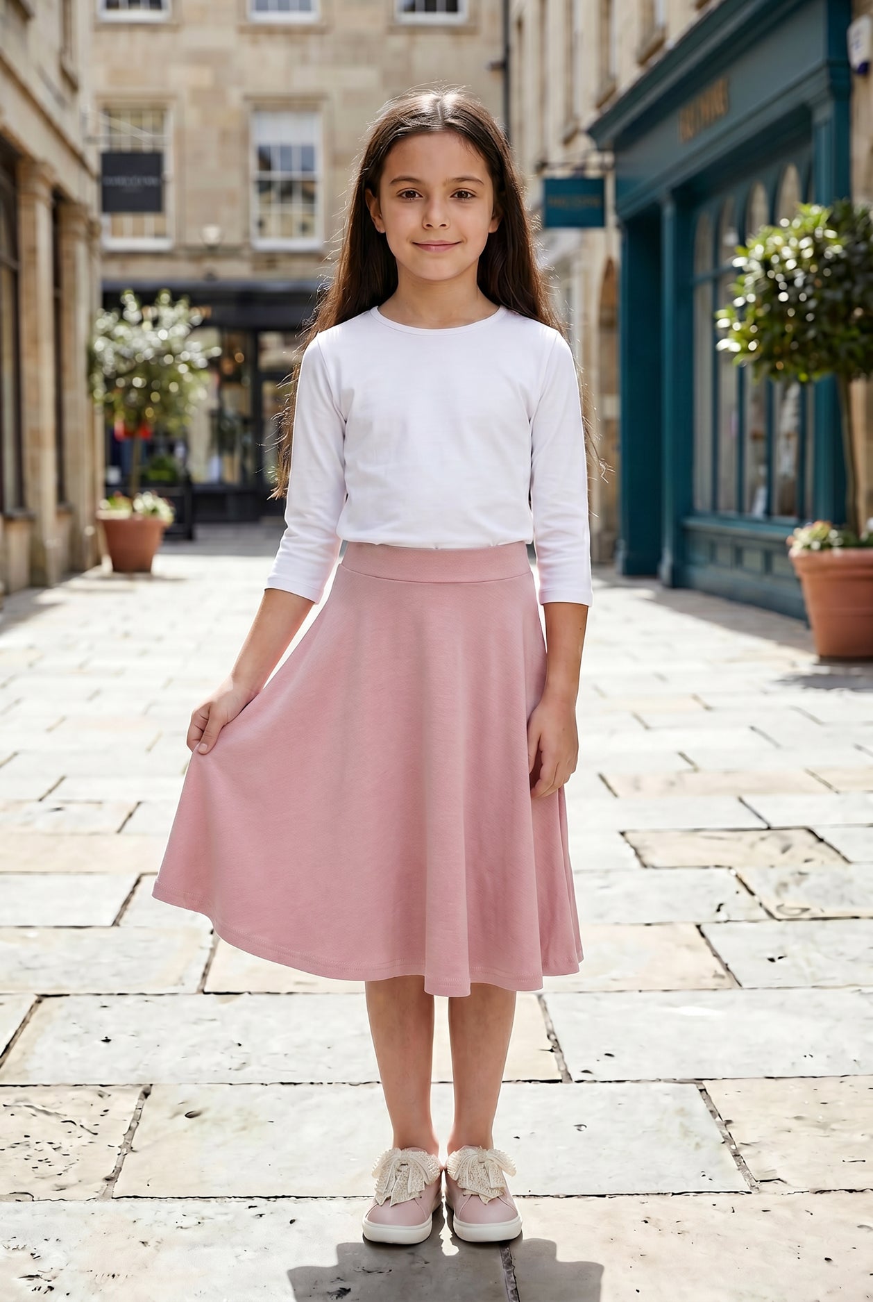 Model wearing Nuggles® Girl's Athleisure Skirt in Dusty Pink