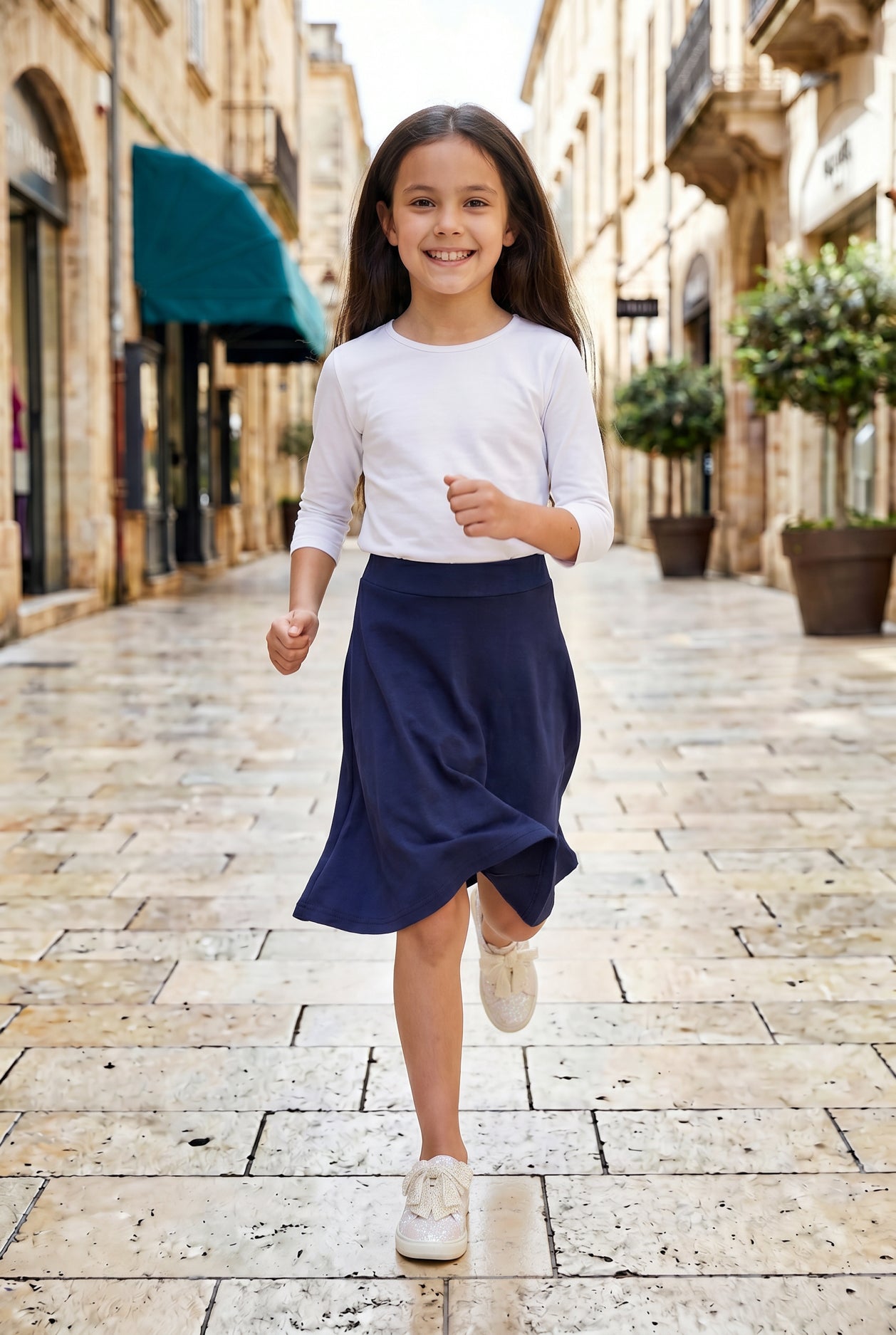 Model wearing Nuggles® Girl's Athleisure Skirt in Navy