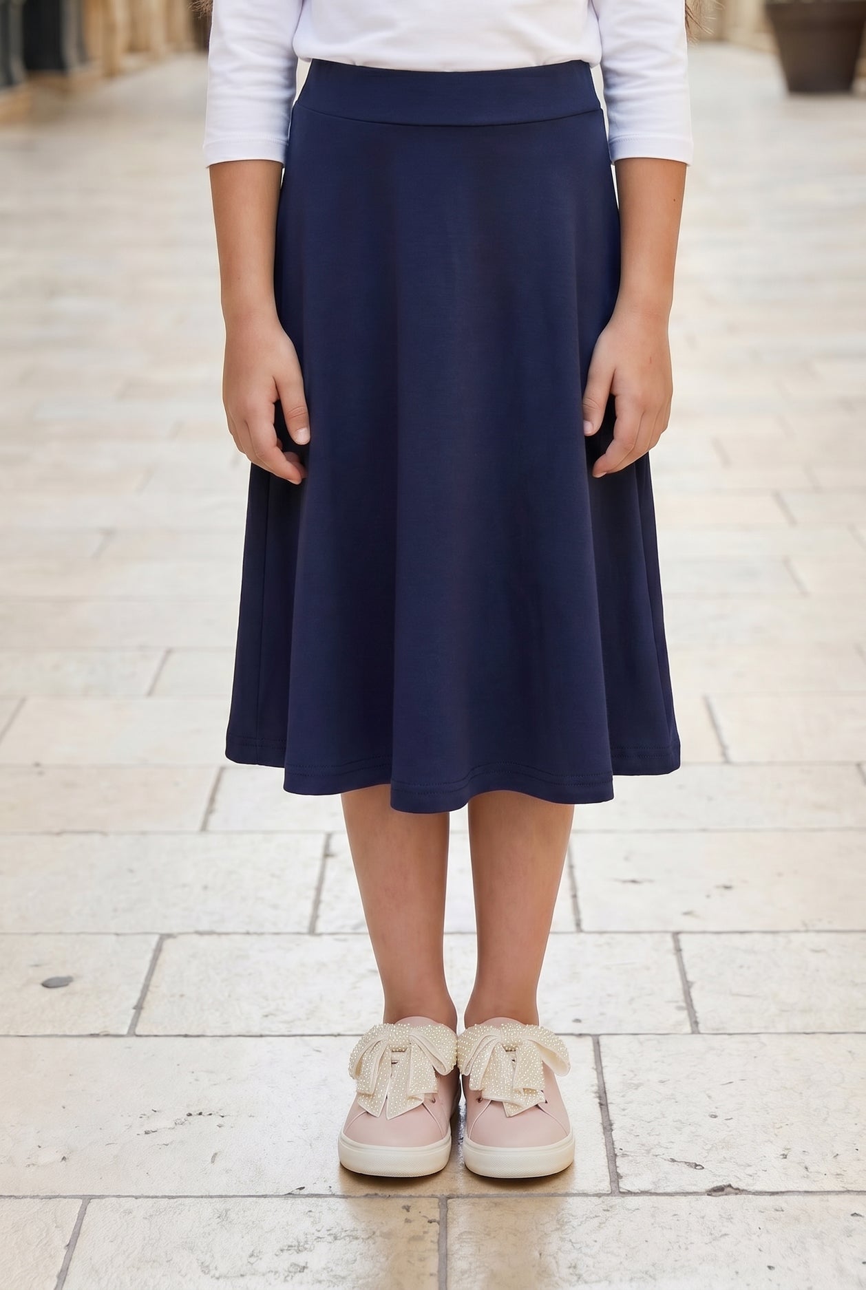 Model wearing Nuggles® Girl's Athleisure Skirt in Navy