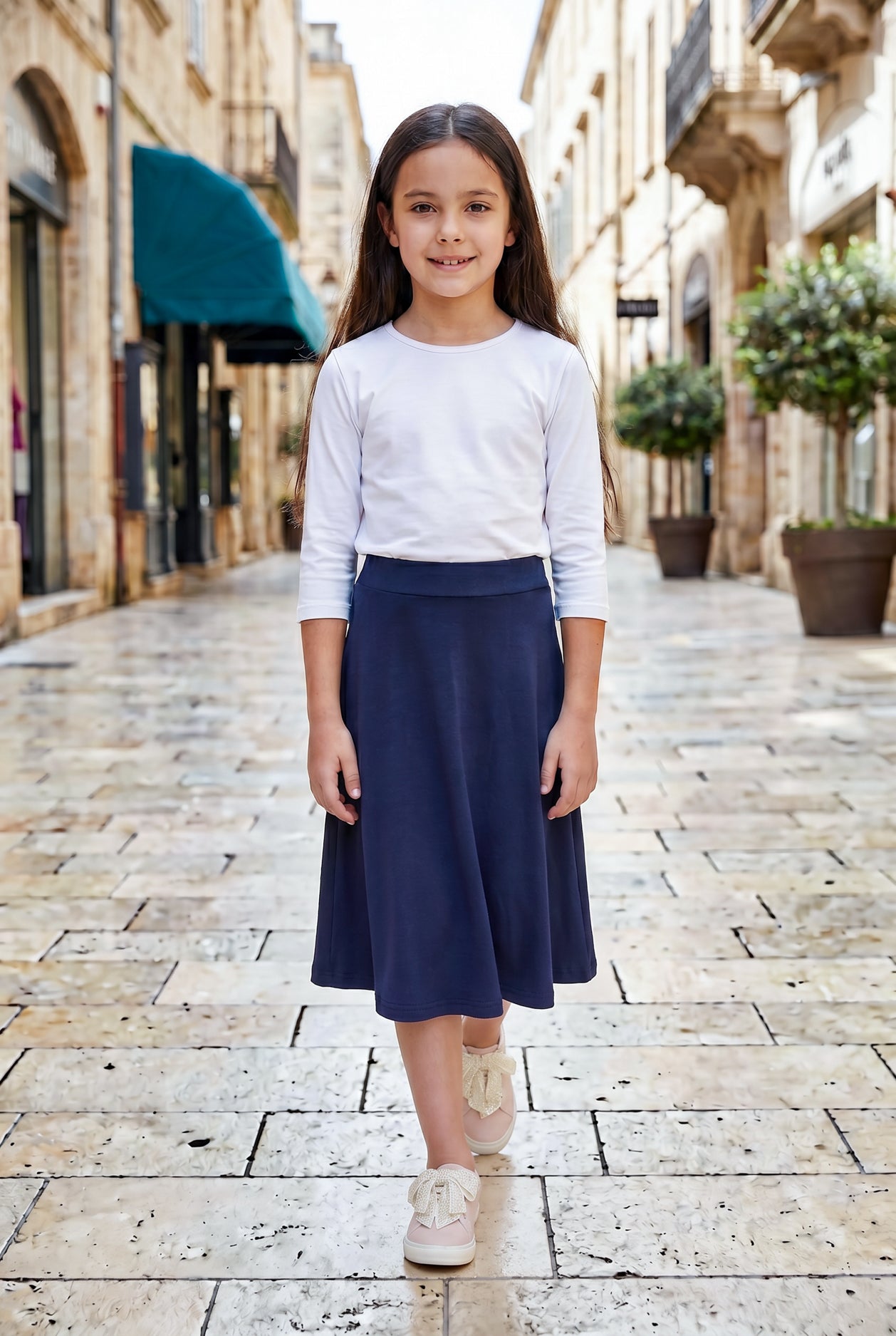 Model wearing Nuggles® Girl's Athleisure Skirt in Navy