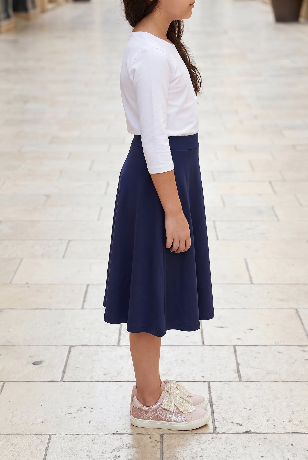 Model wearing Nuggles® Girl's Athleisure Skirt in Navy