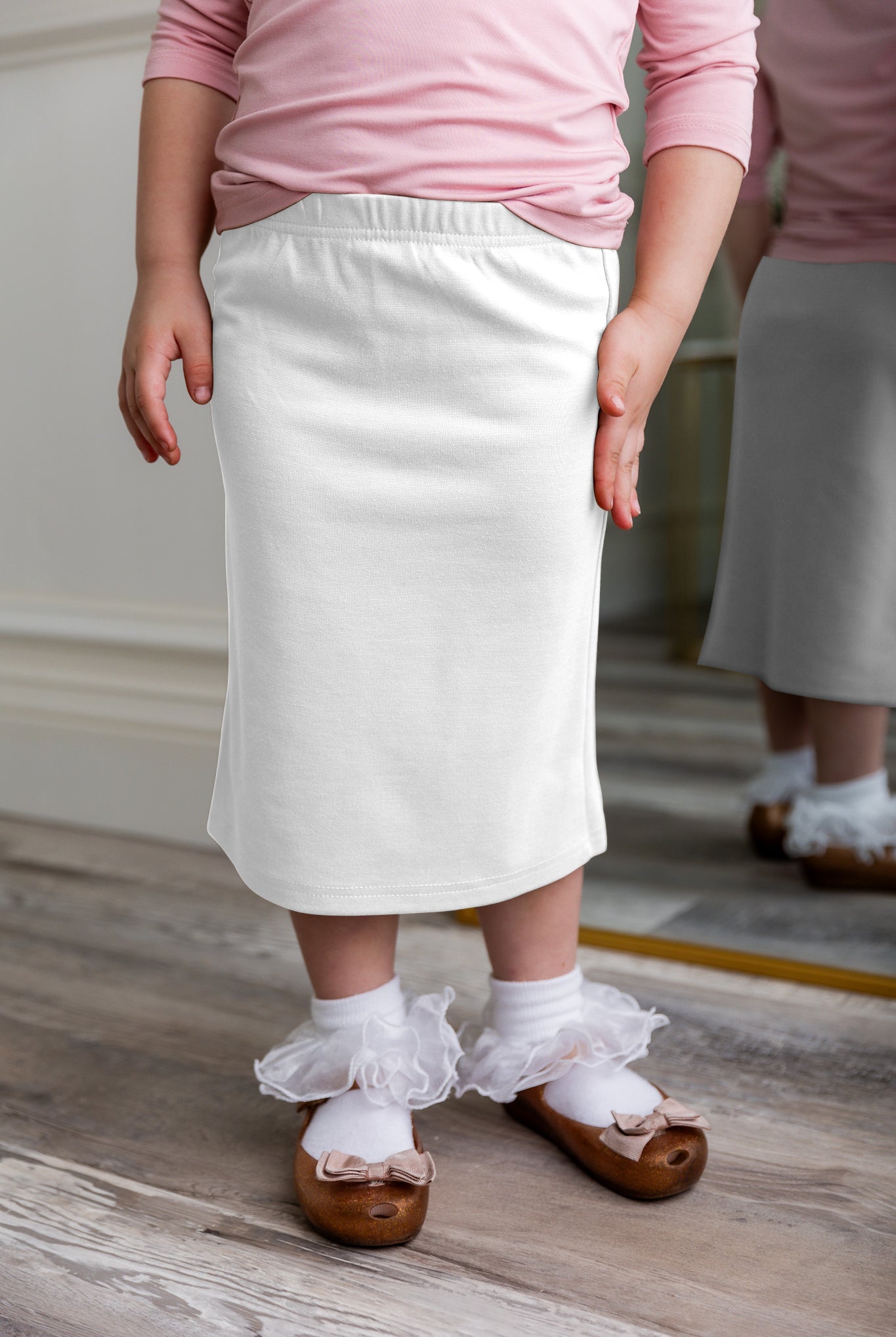 Modest girls' classic midi skirt with soft elastic waistband, knee-length fit, and durable fabric – perfect for everyday wear.