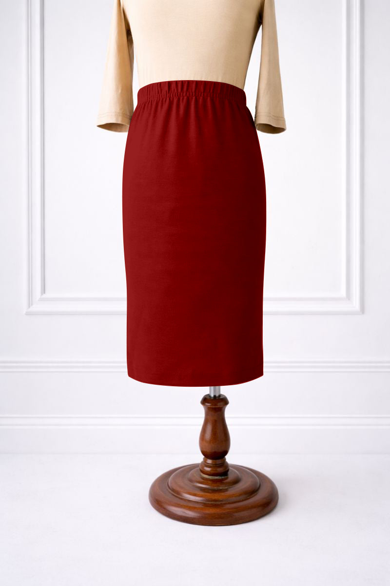 Stock photo of our Nuggles® Girls classic midi skirt elastic waistband and straight silhouette in Brick Red