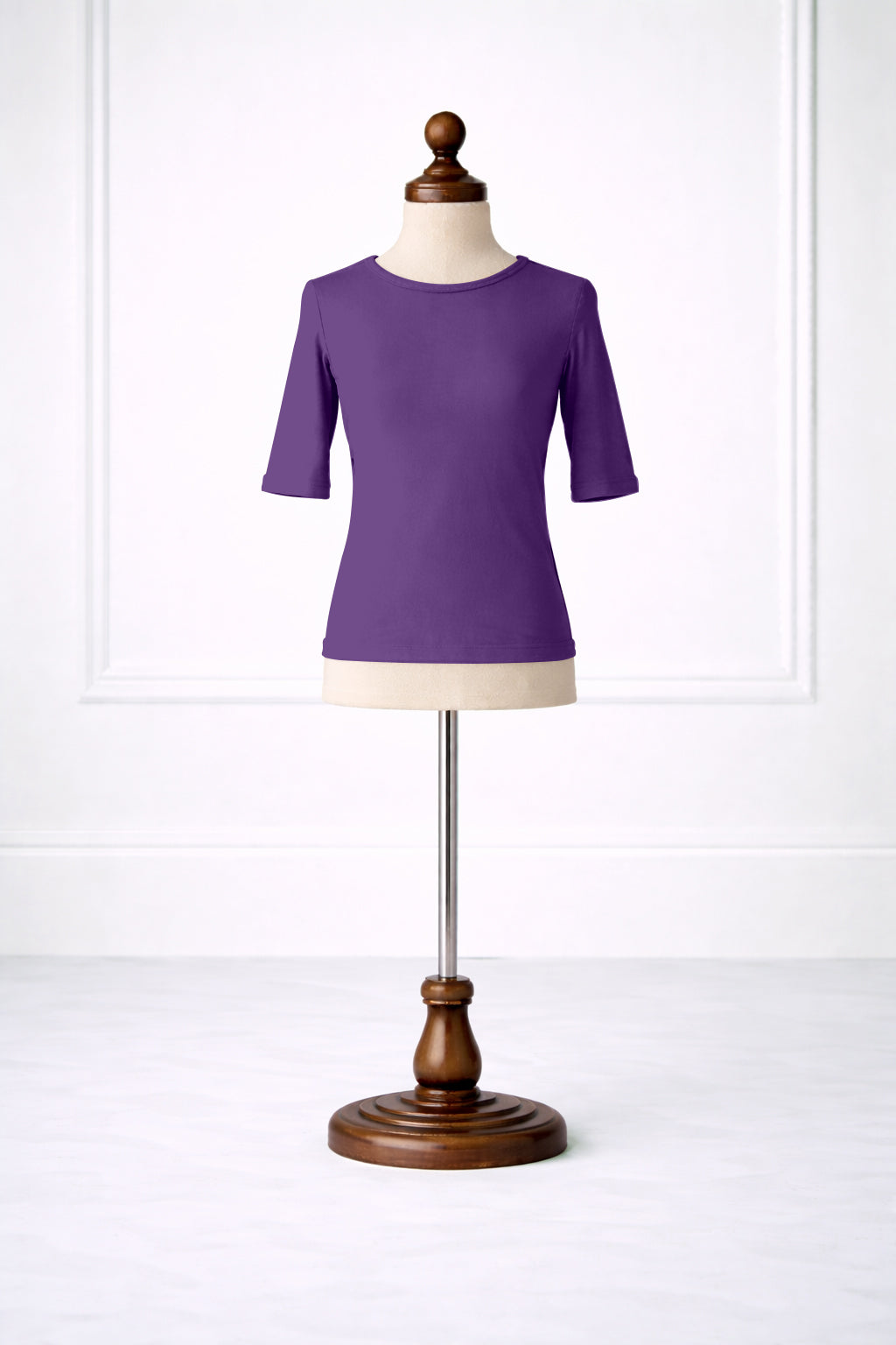 Purple shirt on a mannequin against a white background