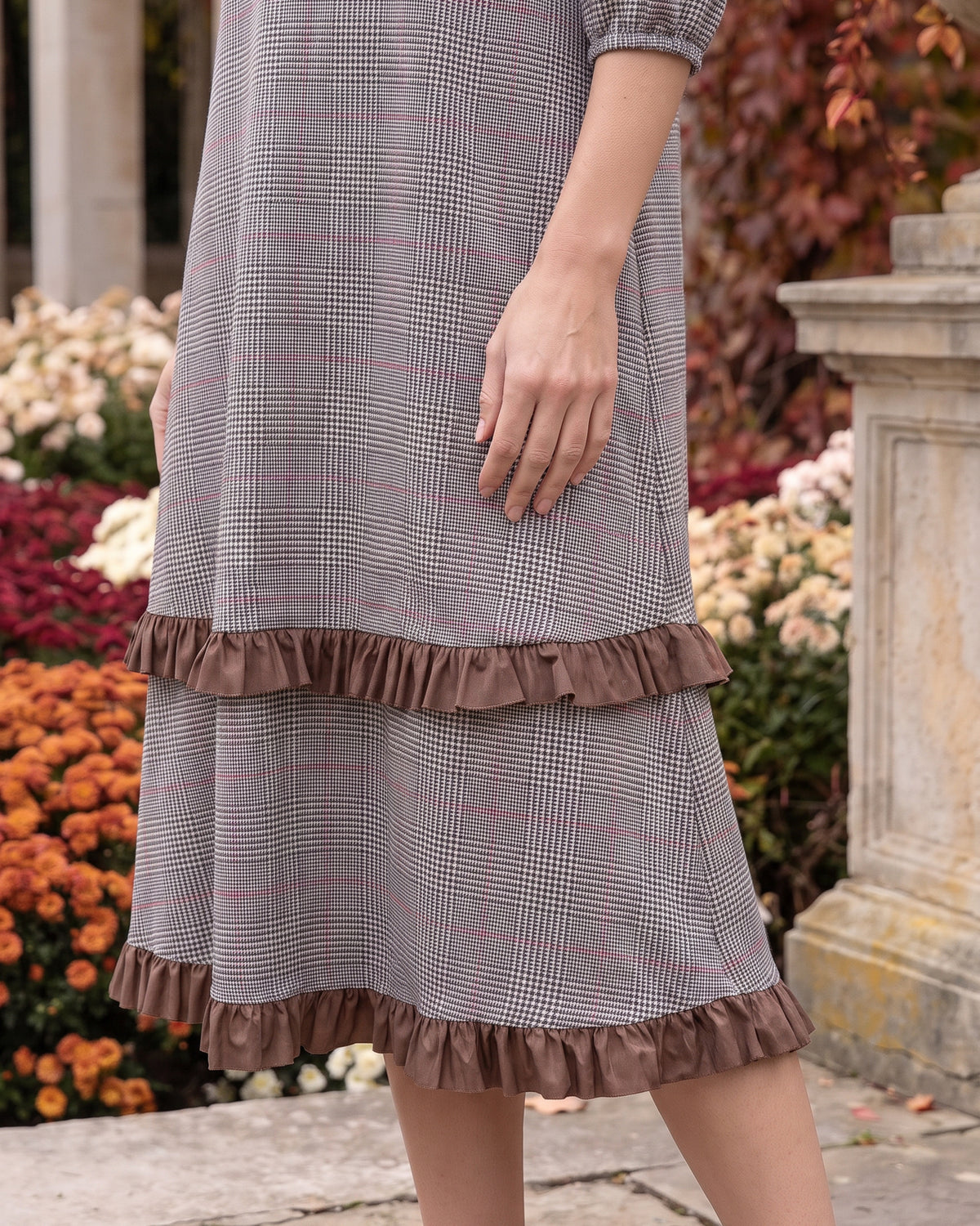 Nuggles® Patricia Dress in Glen Plaid, close crop of the tiered skirt and its two brown ruffles