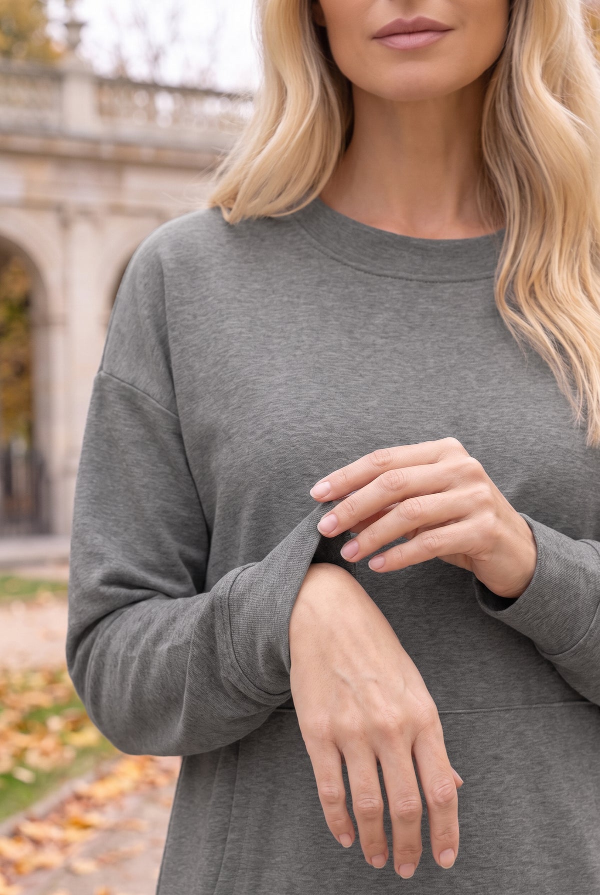 Nuggles® Oakley Hoodie Dress in Heather Gray, close-up of the ribbed sleeve cuff as she adjusts it