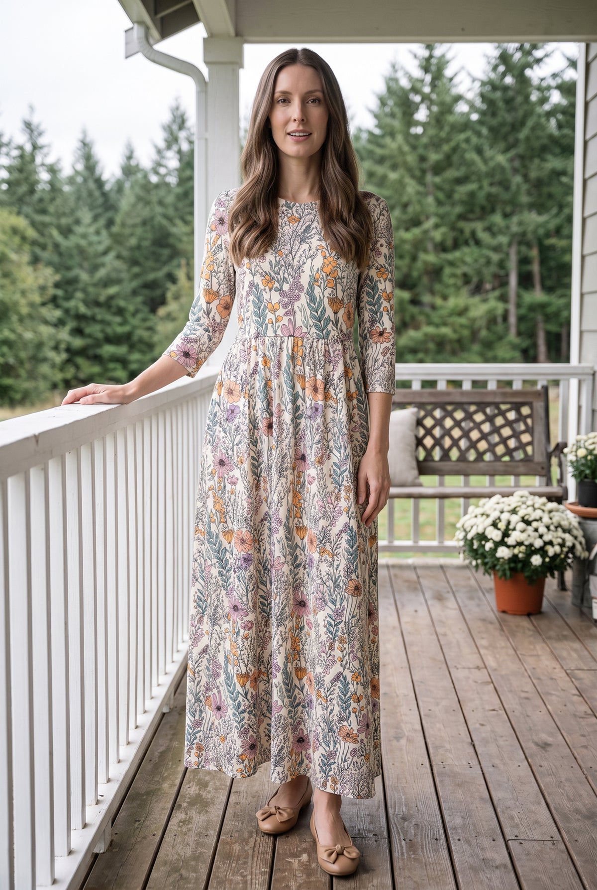 Nuggles® Cleo Maxi Dress in Hedgerow, full length facing the camera with one arm resting on the porch rail