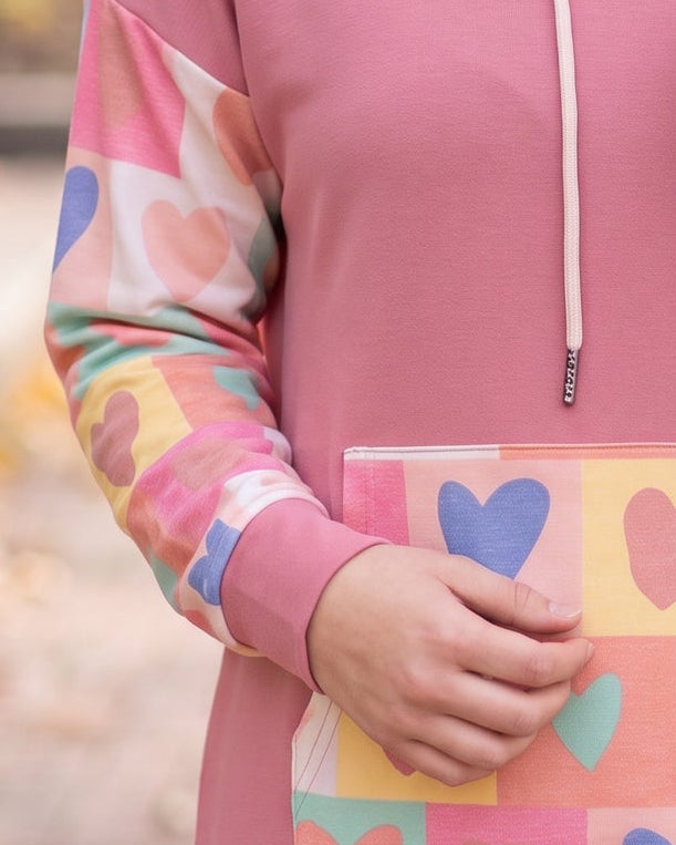 Model wearing Nuggles® Hoodie Dress in Candy Hearts