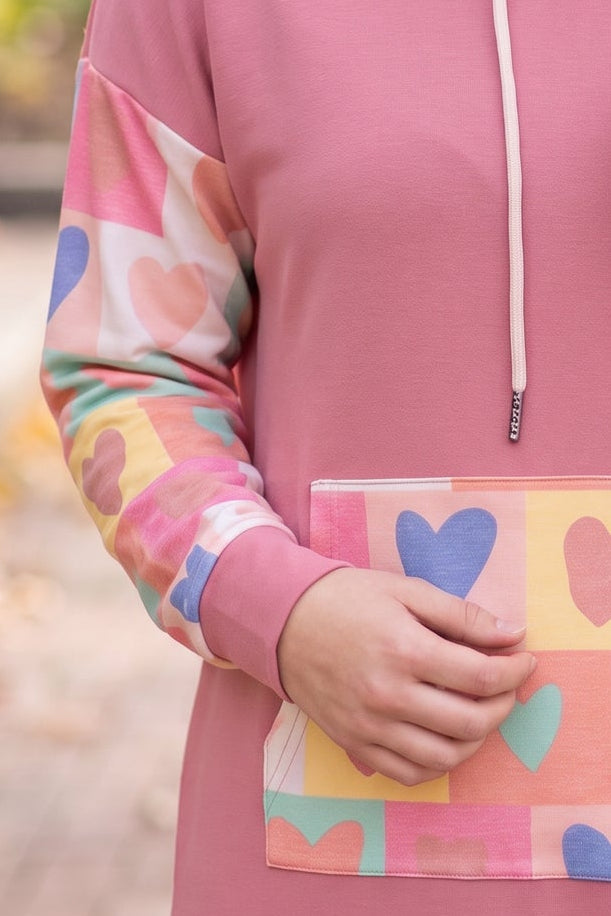 Model wearing Nuggles® Hoodie Dress in Candy Hearts