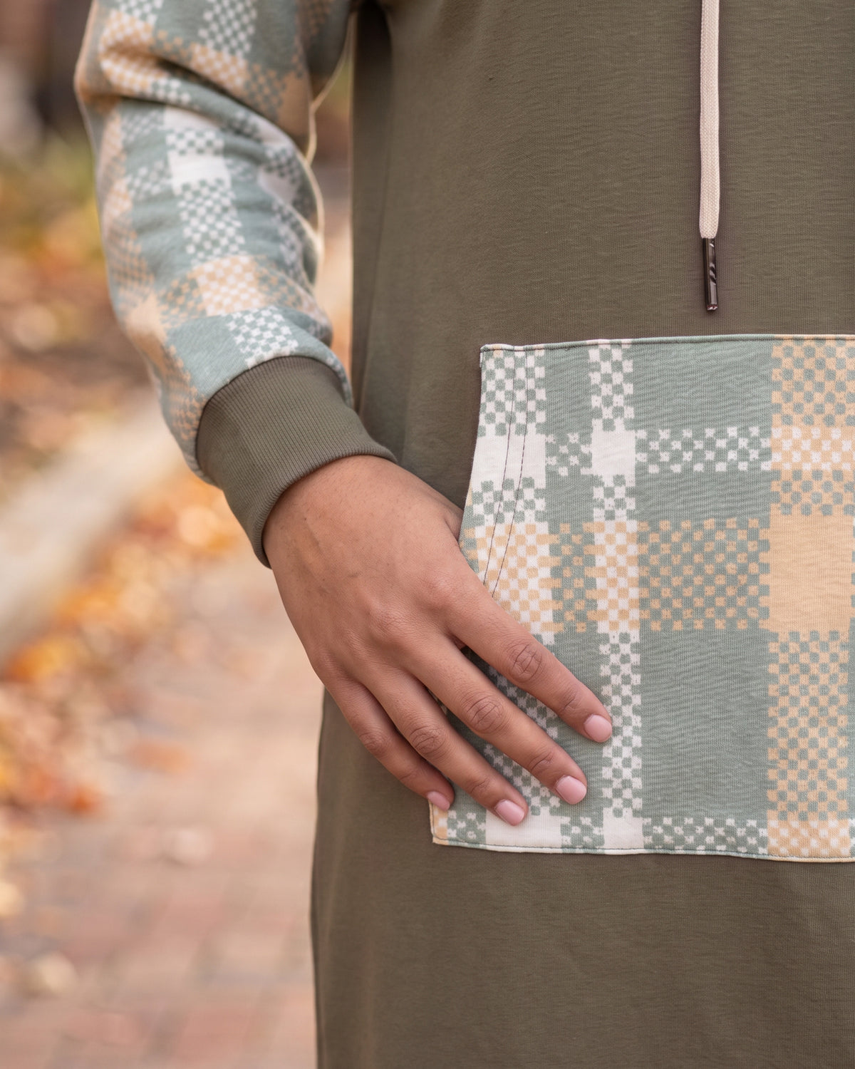 Model wearing Nuggles® Hoodie Dress in Olive Plaid