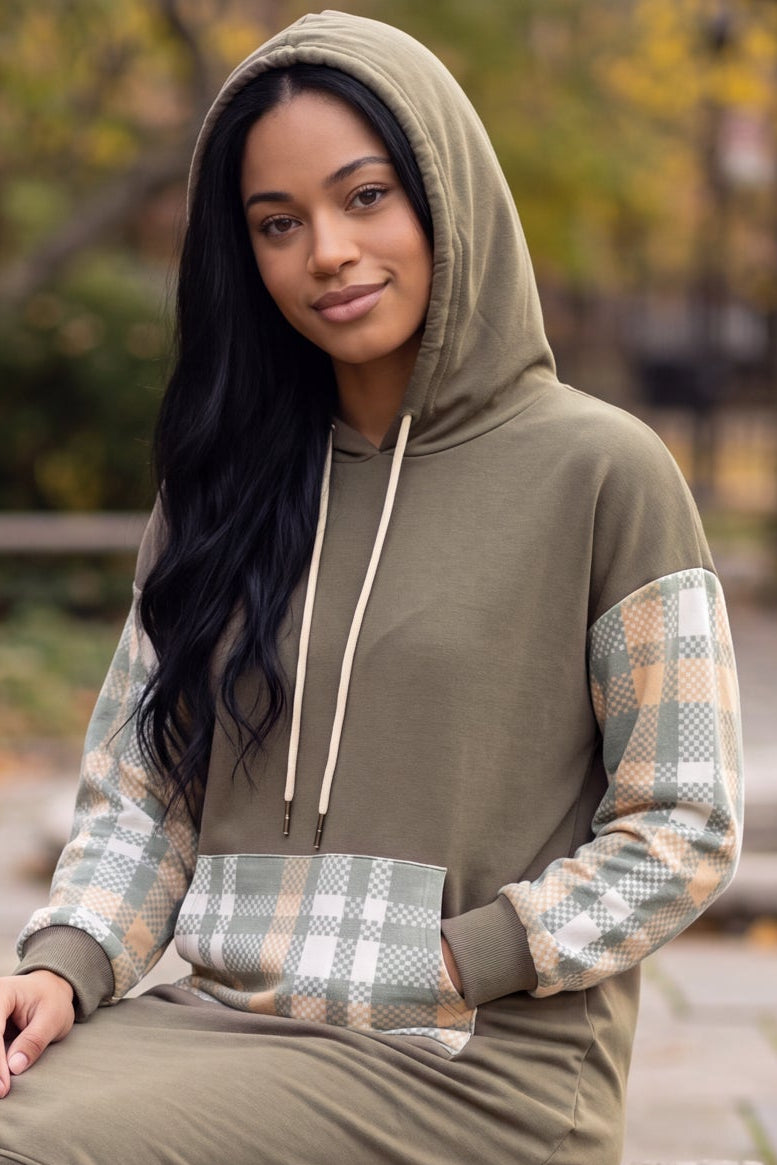 Model wearing Nuggles® Hoodie Dress in Olive Plaid