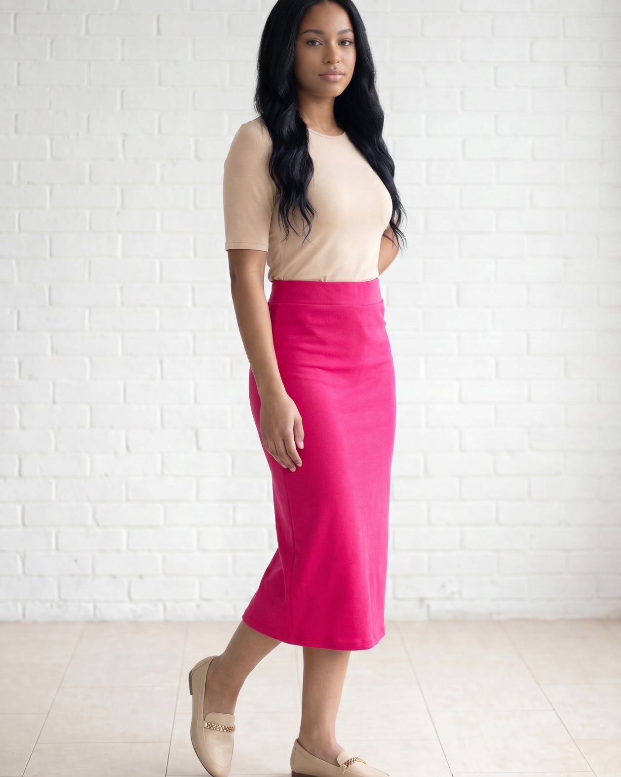 Model wearing Nuggles® 31" Relaxed Skirt in Hot Pink