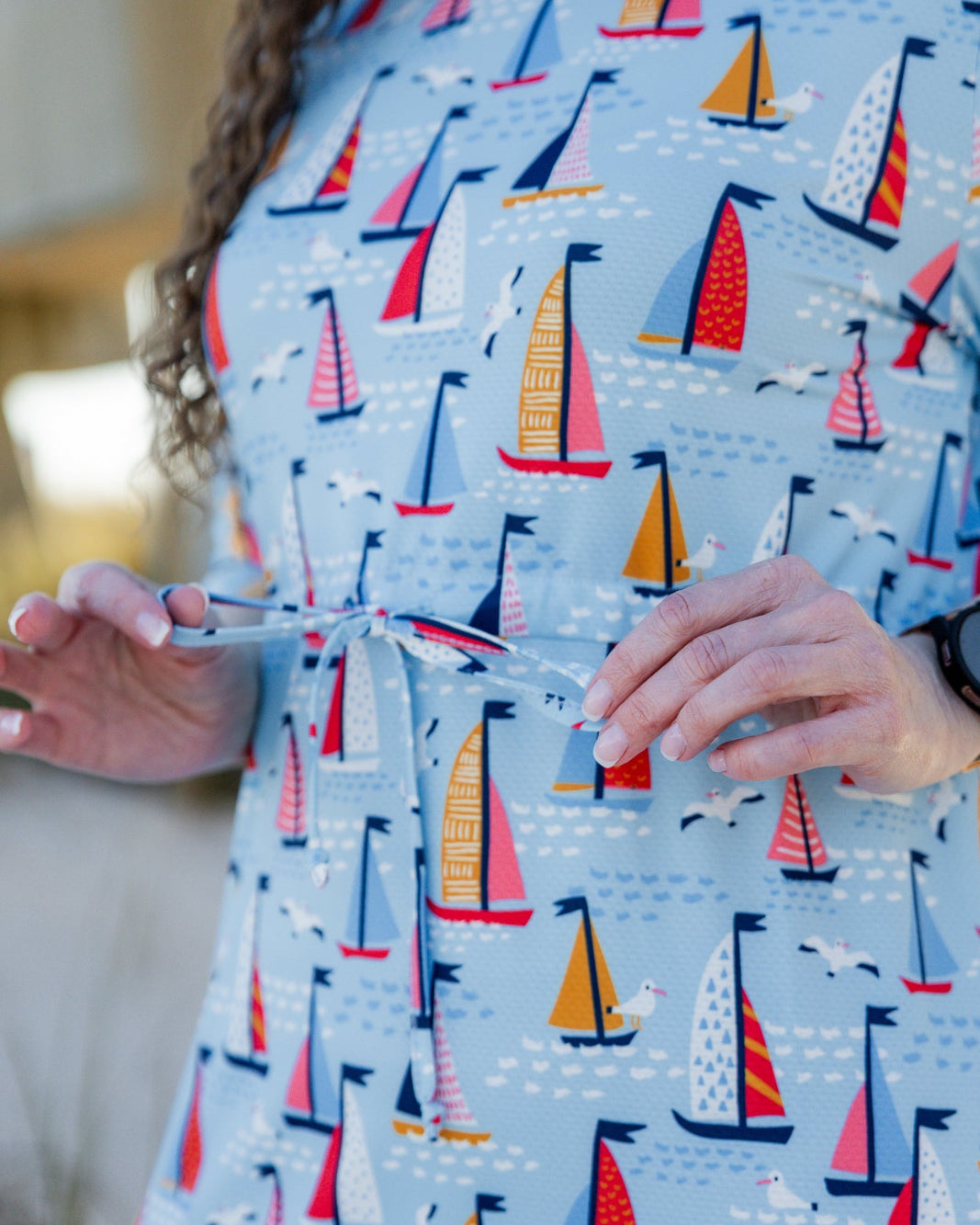 Model wearing Nuggles® Nola Sport Swim Dress in Harbor Sailboats