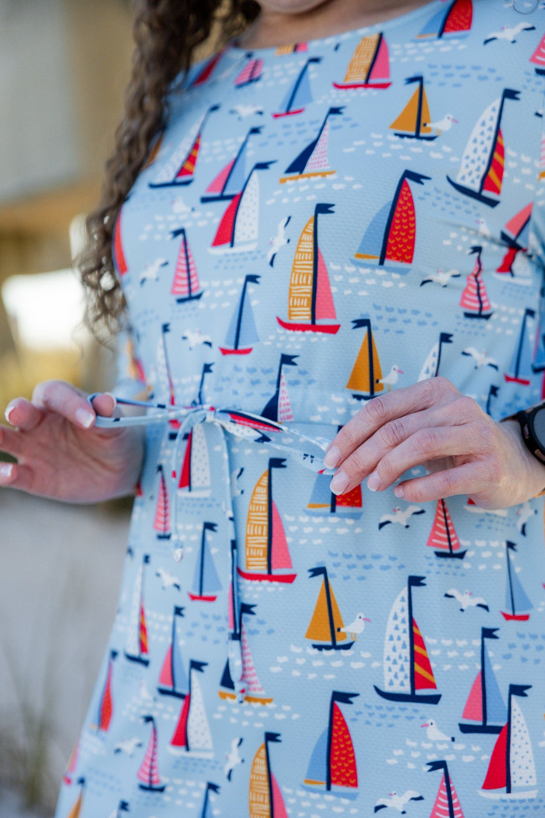 Model wearing Nuggles® Nola Sport Swim Dress in Harbor Sailboats