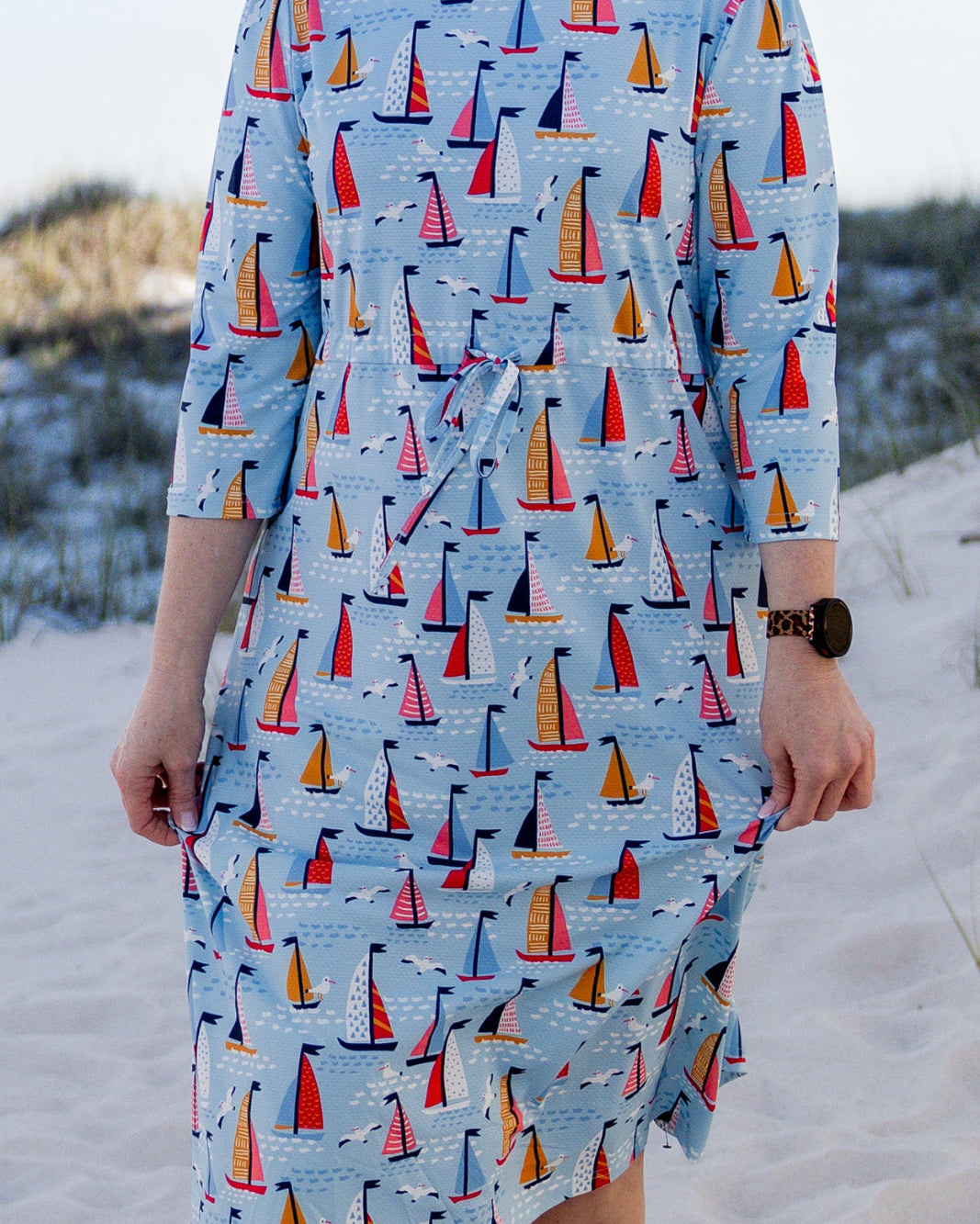 Model wearing Nuggles® Nola Sport Swim Dress in Harbor Sailboats
