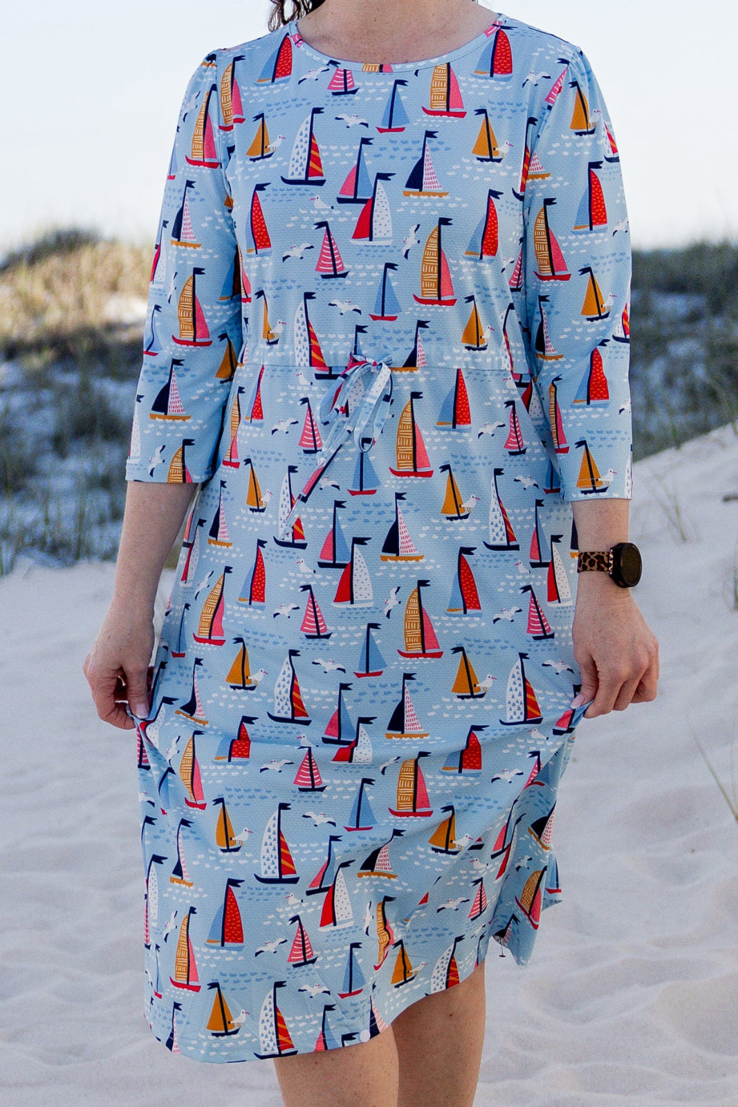 Model wearing Nuggles® Nola Sport Swim Dress in Harbor Sailboats