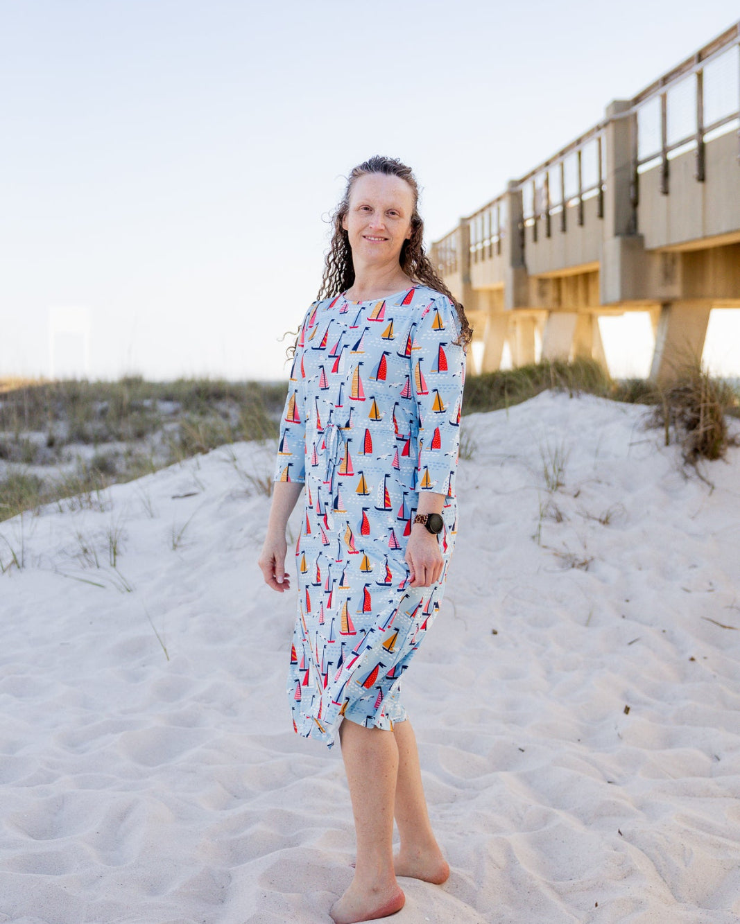 Model wearing Nuggles® Nola Sport Swim Dress in Harbor Sailboats
