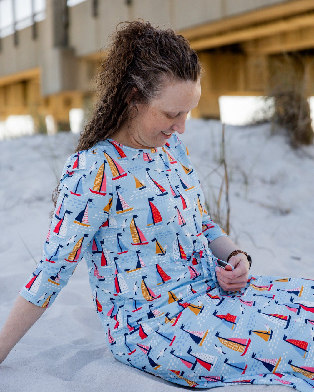 Model wearing Nuggles® Nola Sport Swim Dress in Harbor Sailboats