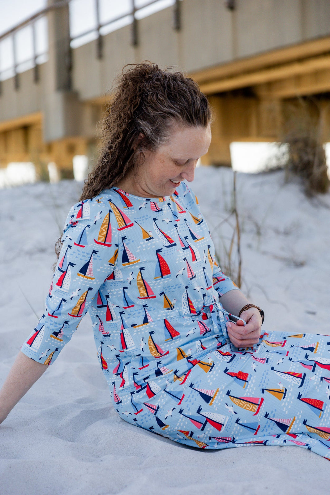 Model wearing Nuggles® Nola Sport Swim Dress in Harbor Sailboats