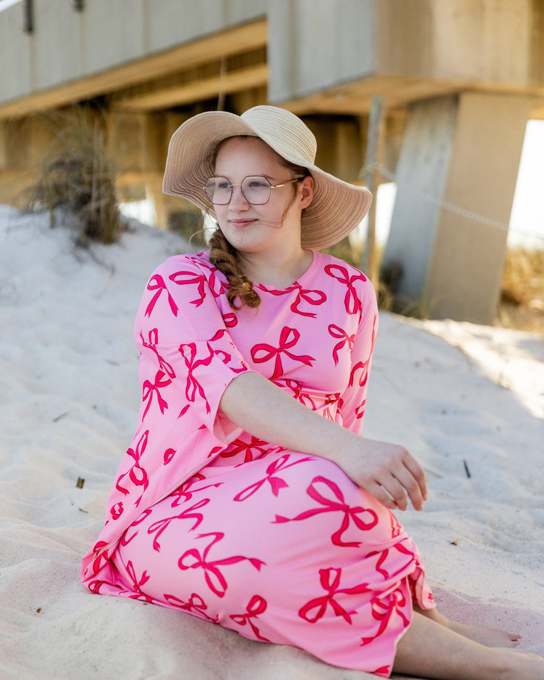 Model wearing Nuggles® Carlie Swim Dress in Pretty Bow