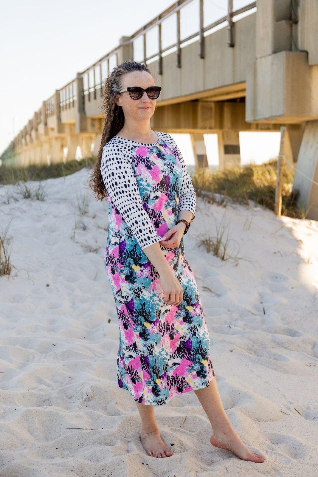 Model wearing Nuggles® Sport Swim Dress in Watercolor Blossom