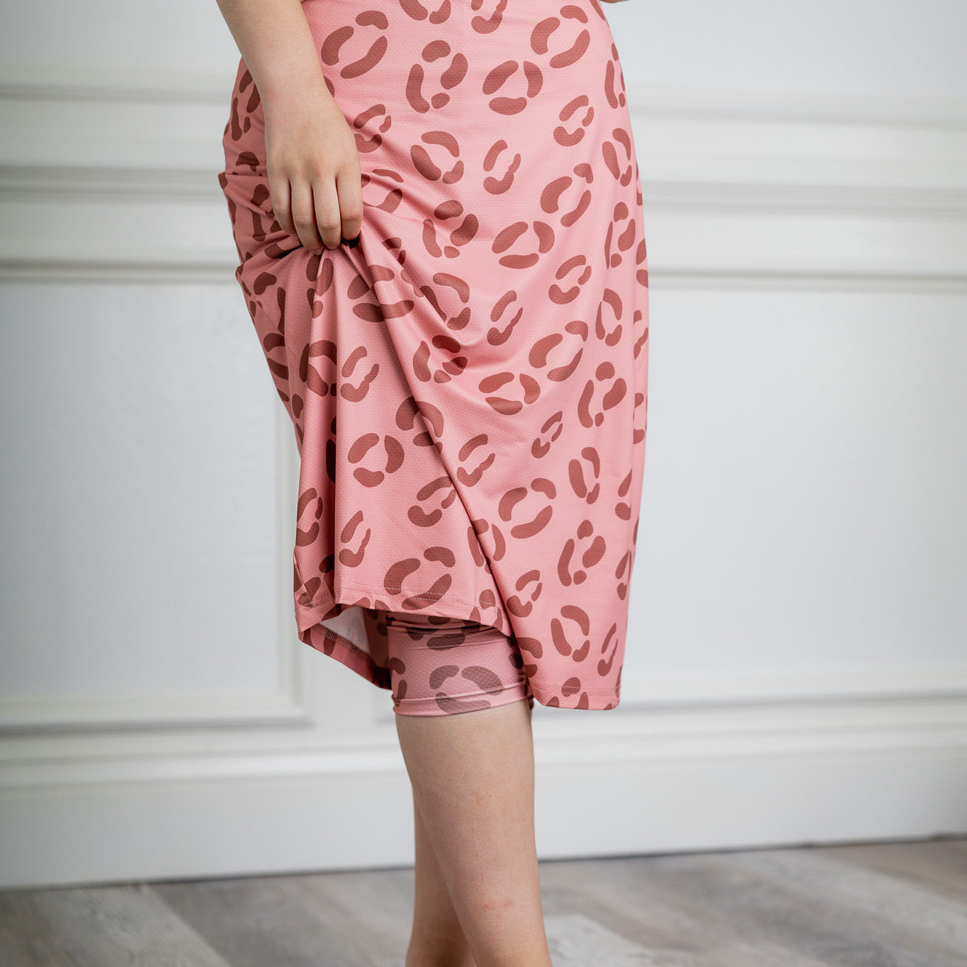 Woman wearing 27-inch tropical flower modest sport skirt with built-in leggings—ideal for activewear, cycling, running, swimming, and workouts.