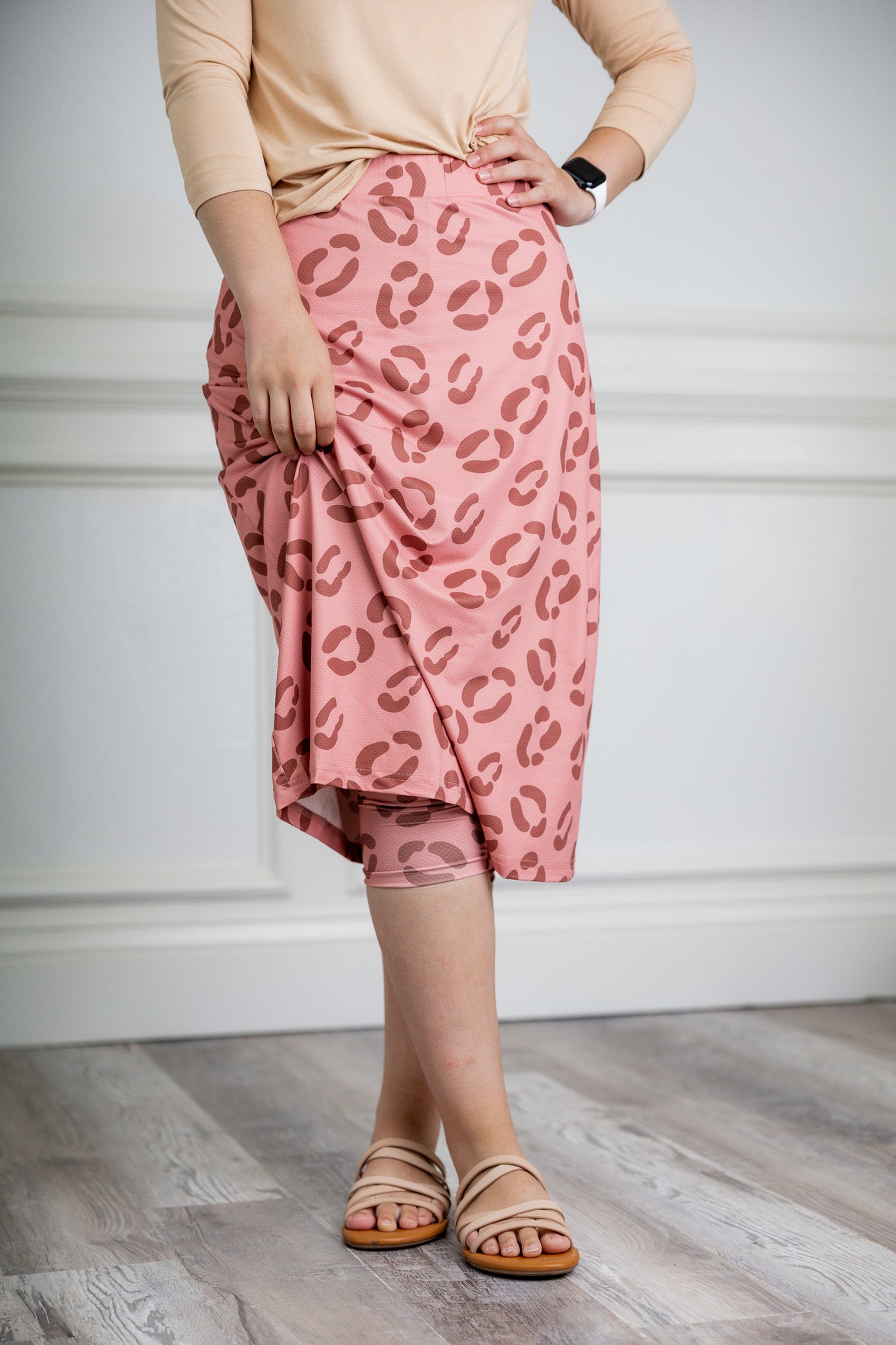 Woman wearing 27-inch tropical flower modest sport skirt with built-in leggings—ideal for activewear, cycling, running, swimming, and workouts.