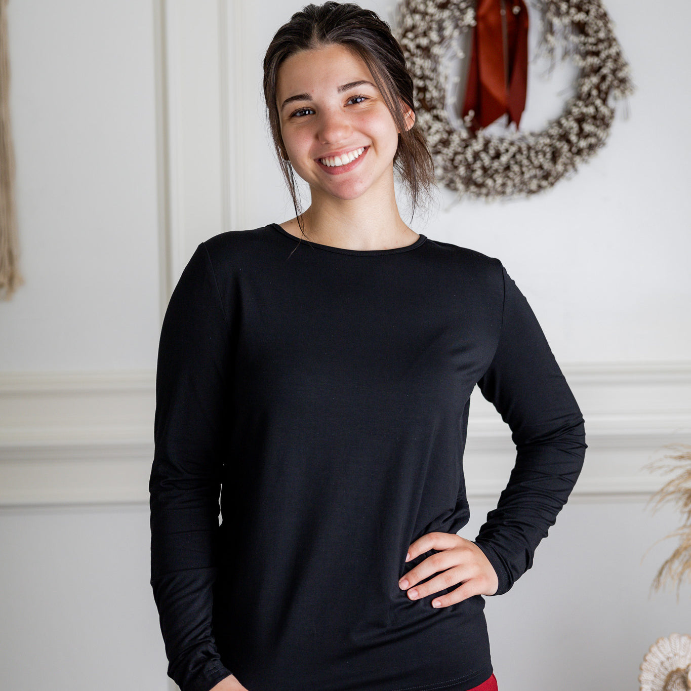 Model styling a neutral Nuggles® long sleeve top for casual everyday outfit inspiration.
