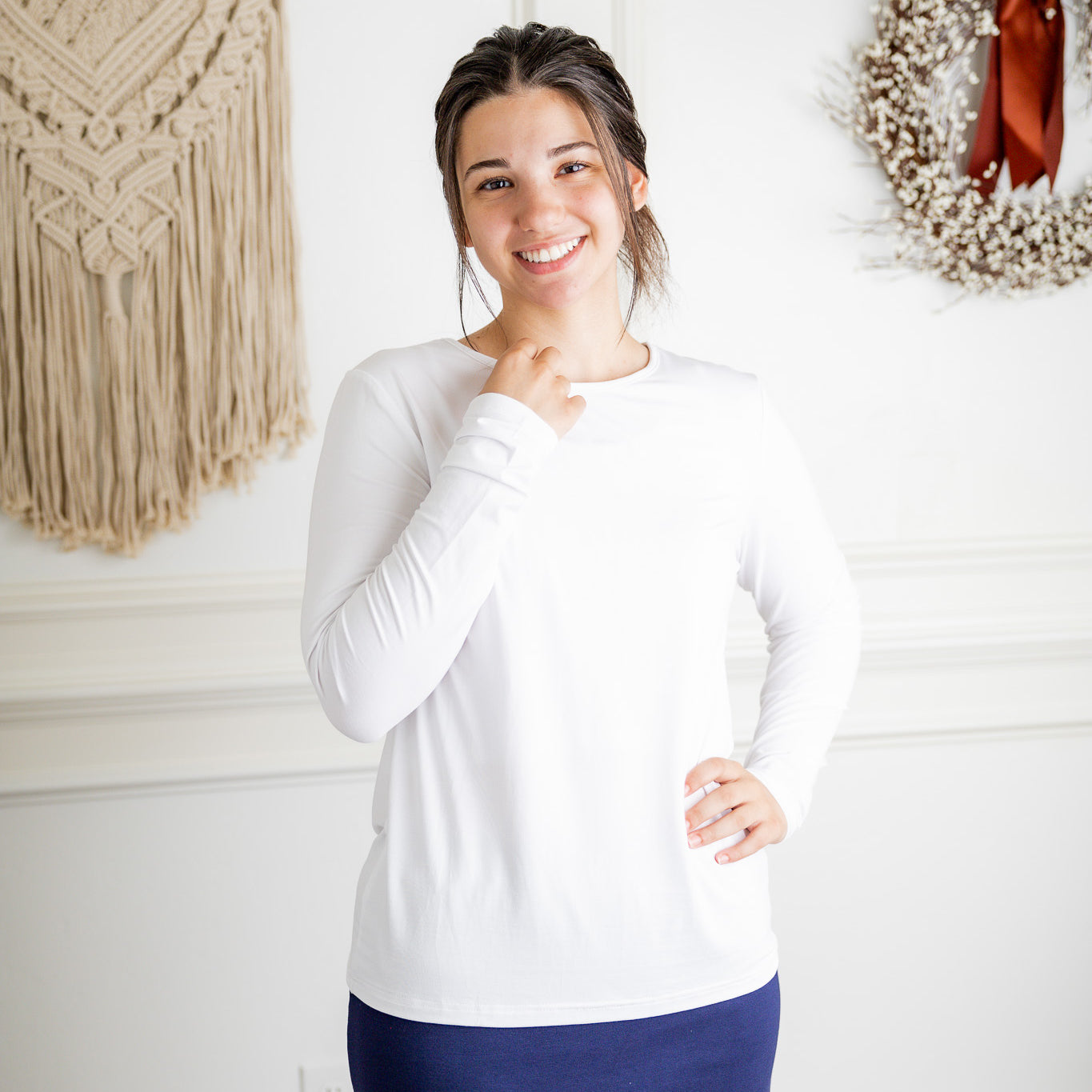 Model styling a neutral Nuggles® long sleeve top for casual everyday outfit inspiration.