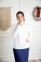 Model styling a neutral Nuggles® long sleeve top for casual everyday outfit inspiration.