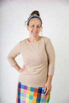 Model wearing the  Nuggles®  Essential 3/4 Tee in ribbed fabric, a modest, fitted top with 3/4 sleeves and a rounded neckline. Shown in a neutral tone, ideal for layering.